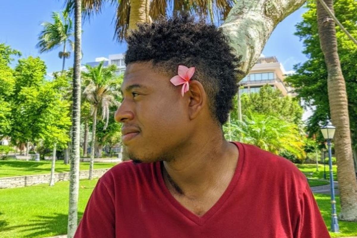 Jerry Goss '23 with flower in hair.