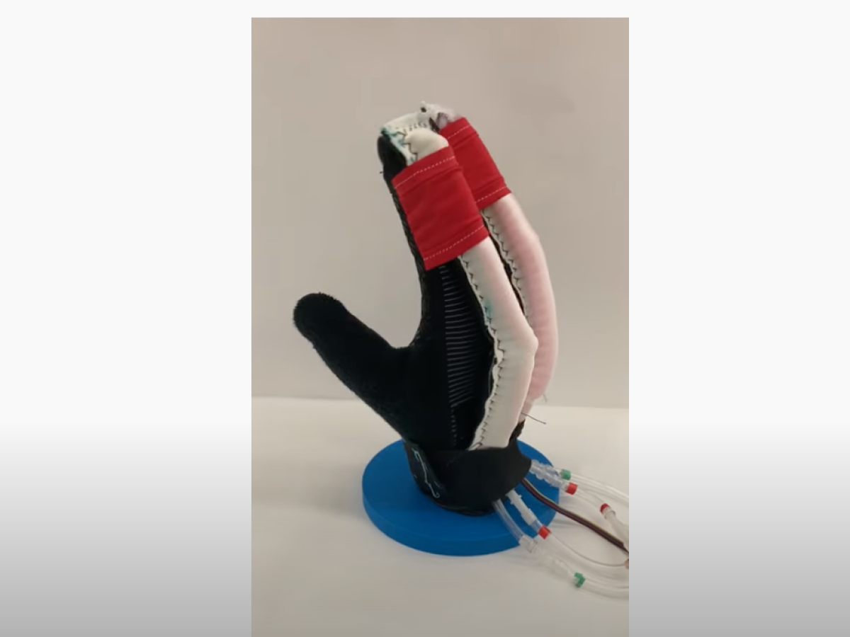 A prototype of a glove with integrated sensors and actuators that can move fingers through a prescribed range of motion.