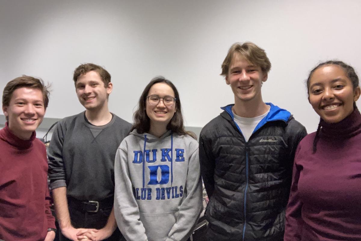 Five of the six Olin PEEP Lab students stand shoulder-to-shoulder for a photo.