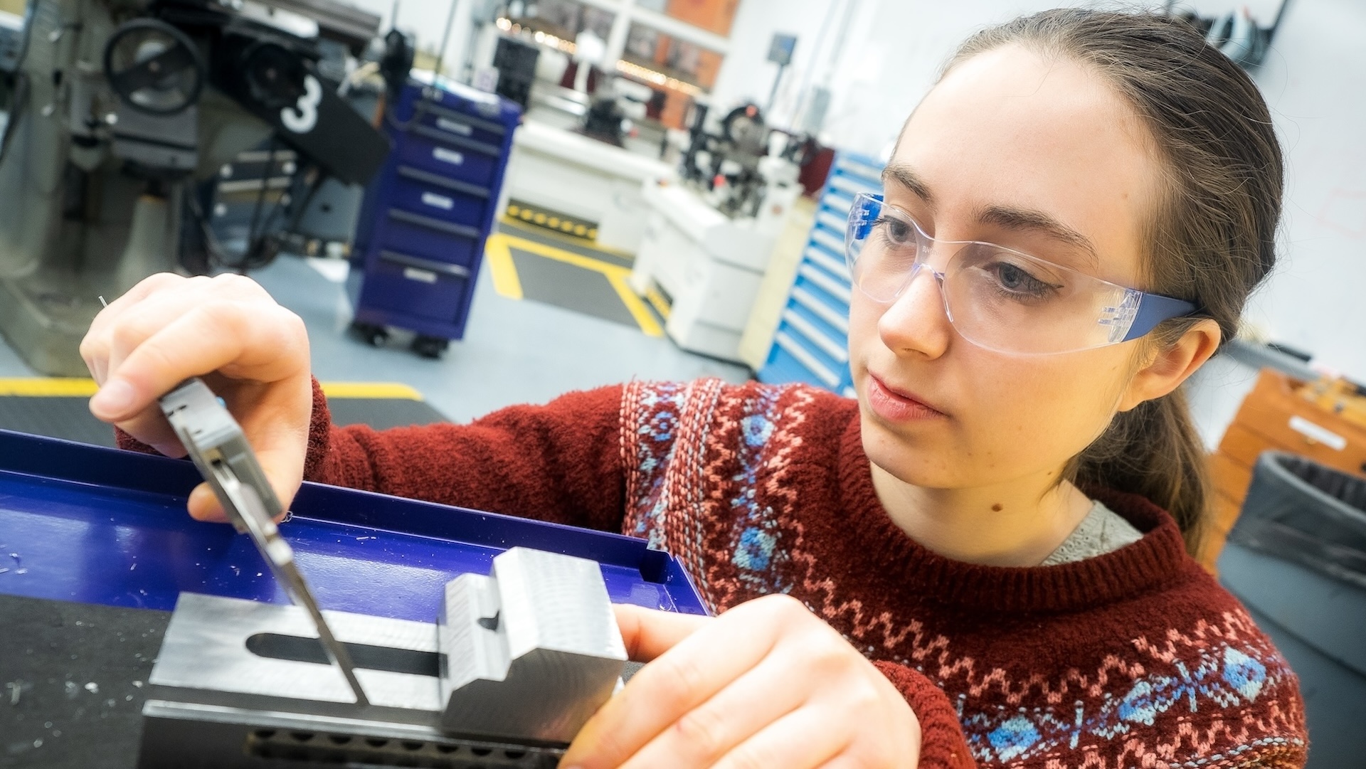 An engineering student works in the machine shop.