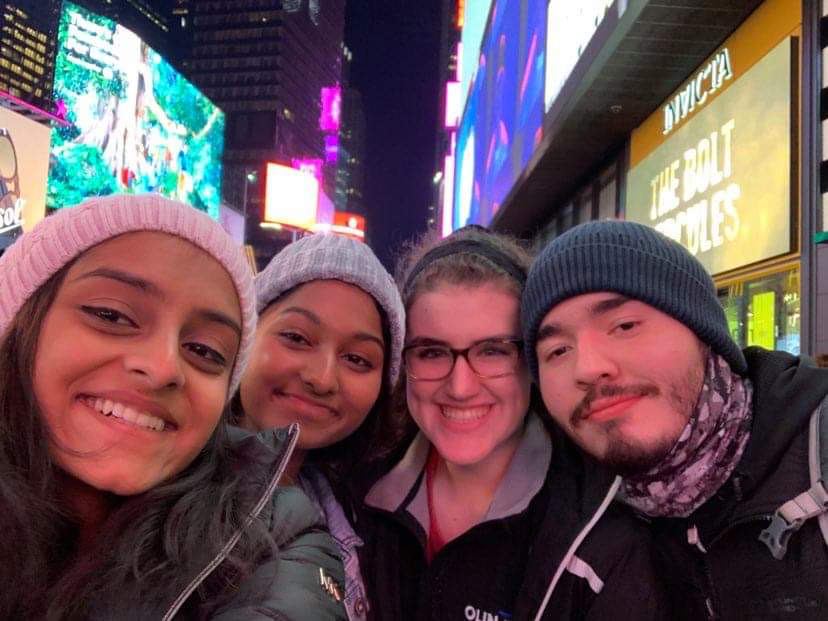 A group of friends in a city at night.