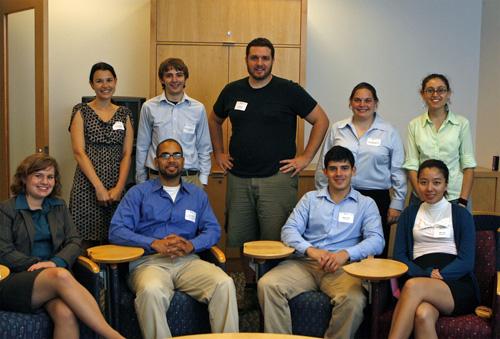 Team members standing and sitting