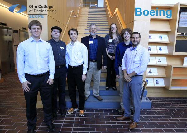 Team members standing at the main staircase in Milas Hall