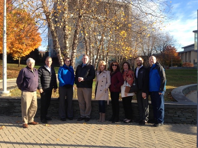 A group of people outside on campus on a fall day.