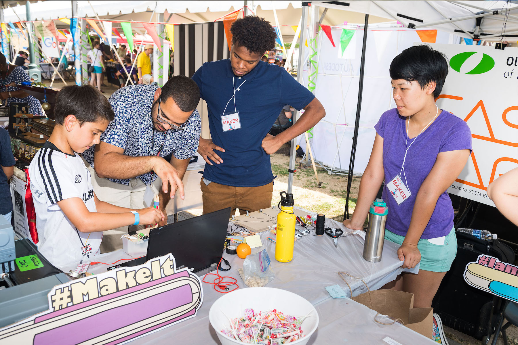 Professor Amon Millner helps a community member with a coding project in Roslindale, MA, in 2016.