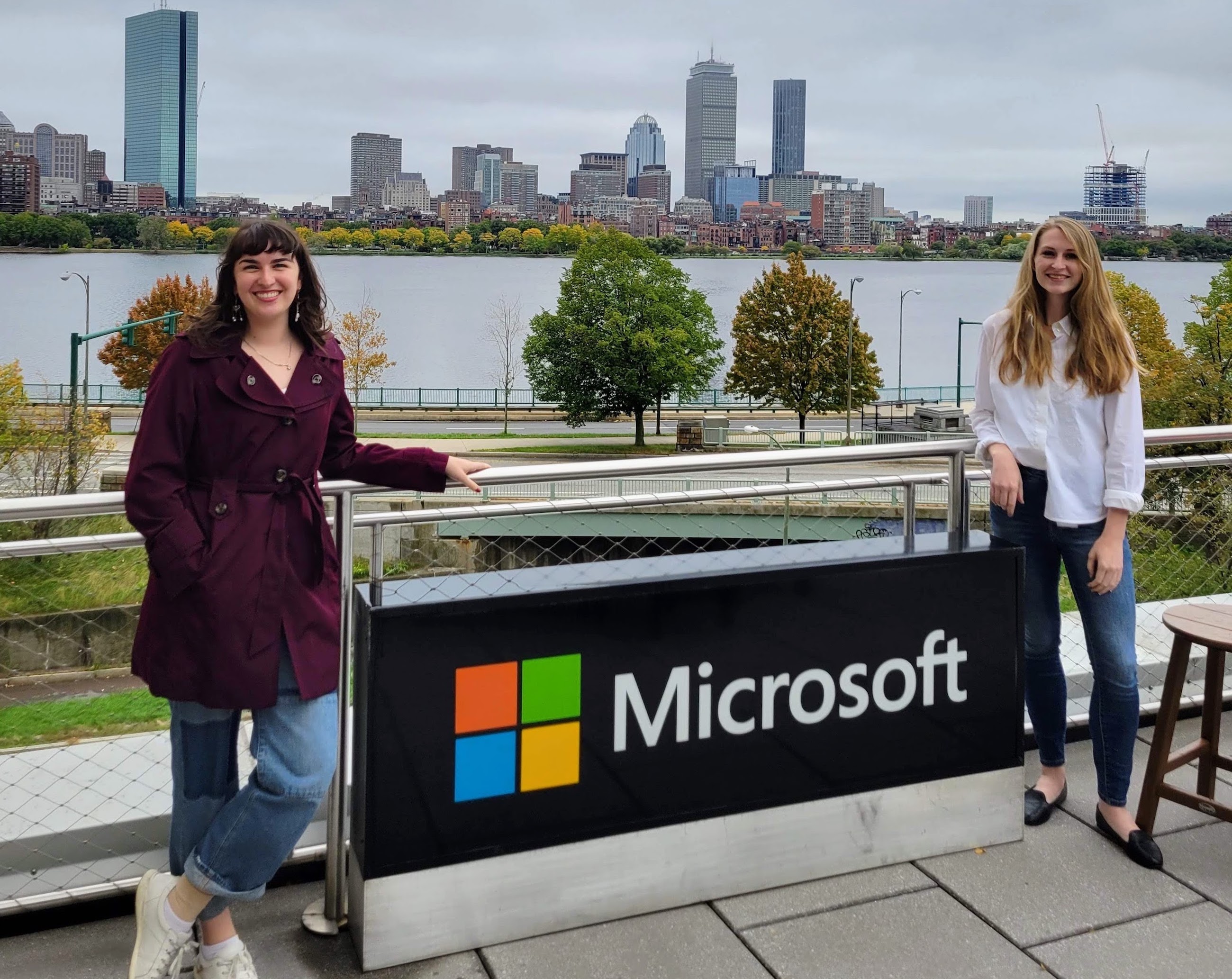 Gracey Wilson '20 and Allison Basore '20 stand on opposite sides of an outside Microsoft sign.