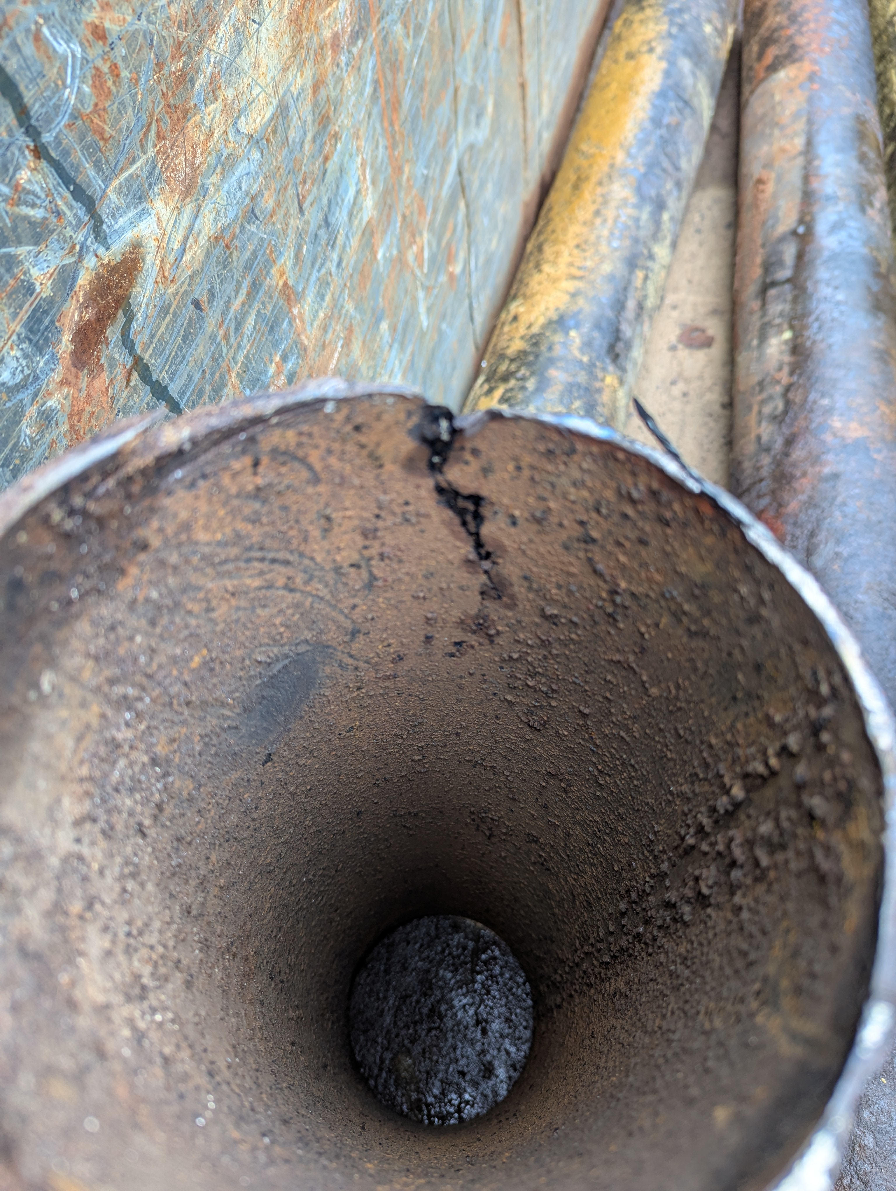 This section of pipe has most its metal corroded away. A bump by workers removing its insulation poked a hole in the thinned wall (see crack).