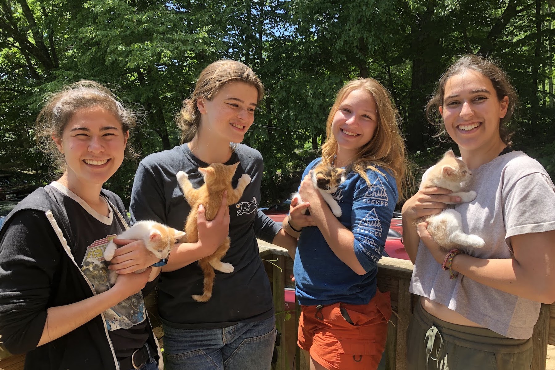 Caitlin '23, Stella '24, Sophia ’24 and Olivia ’22 hold newborn kittens at Woodland Farm.