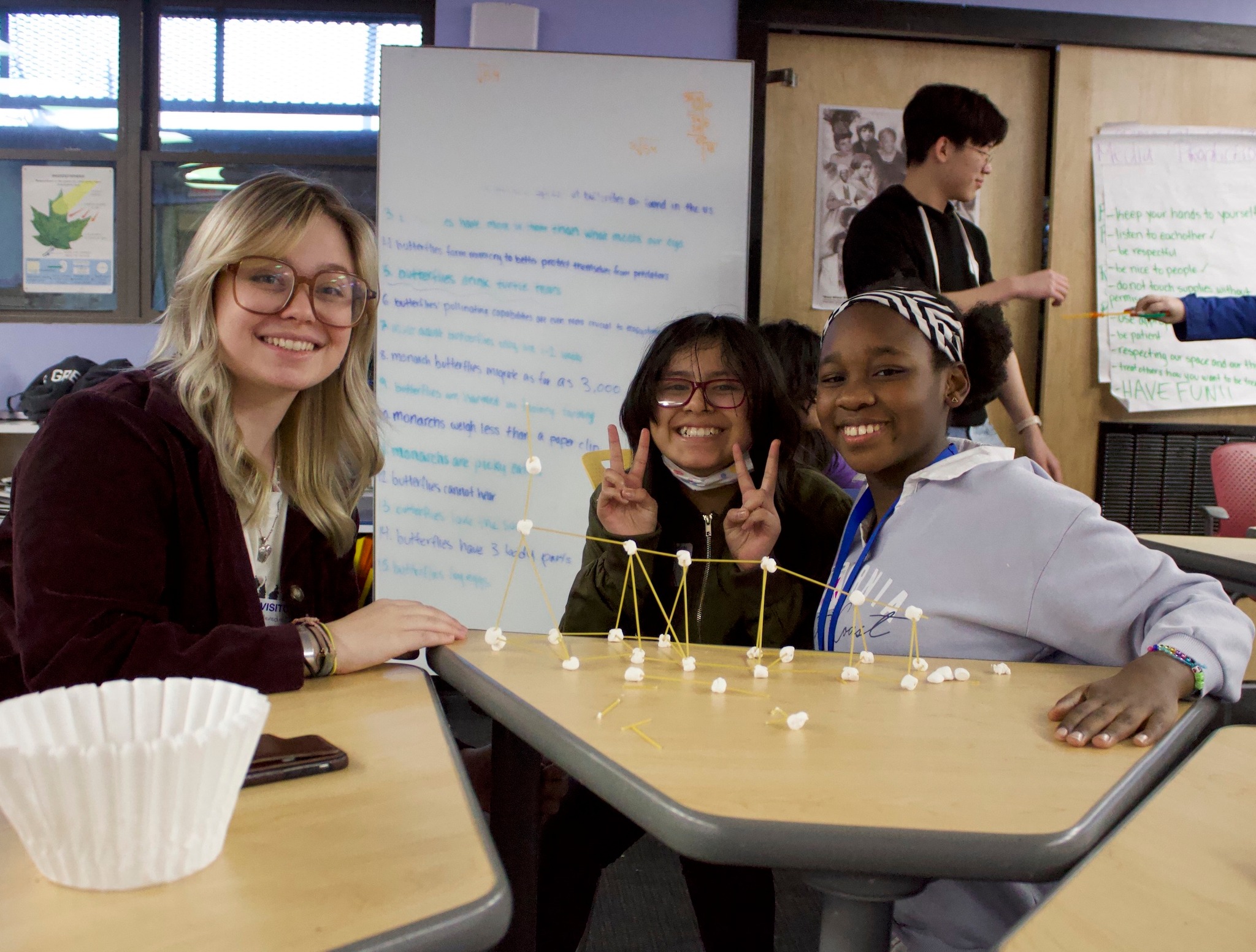 Meredith Alley, Co'25, and Boys & Girls Club students posing with their spaghetti tower during the programs second exploratory visit.
