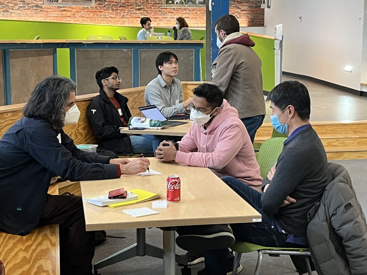 Junior Adi Sudhakar and Senior James Ho discuss their new business idea YDOT – a testing platform - with Greentown Labs engineers.