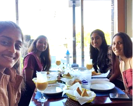 The author seated at a restaurant table with three friends.