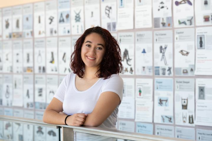 Olivia Jo Bradley '23 Olin College student Olivia Jo Bradley '23, in a white shirt and smiling at the camera, poses in front of a wall in the Academic Building.