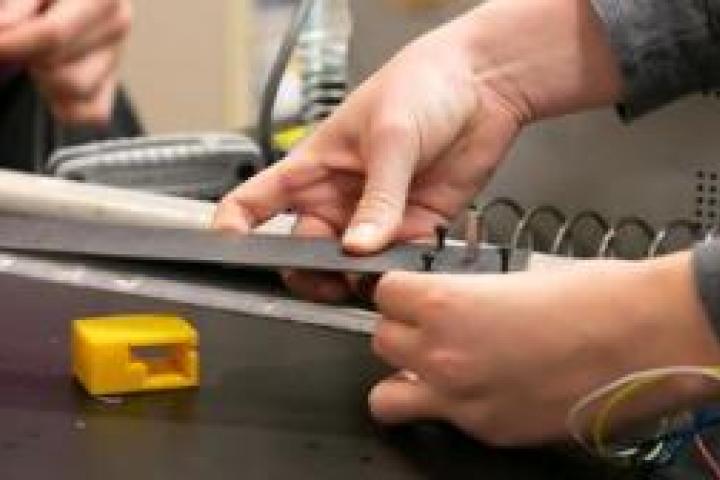 Closeup of people working in the Olin Shop.