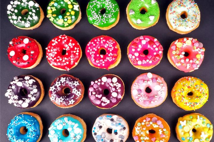 A photo of 20 colorful donuts in four rows of five