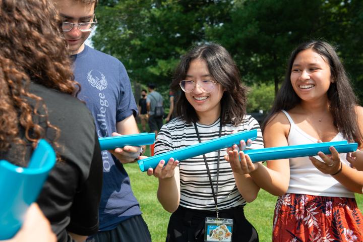 Olin students participate in ice breaker activities during Orientation A photo of two Olin students smiling as they work side by side