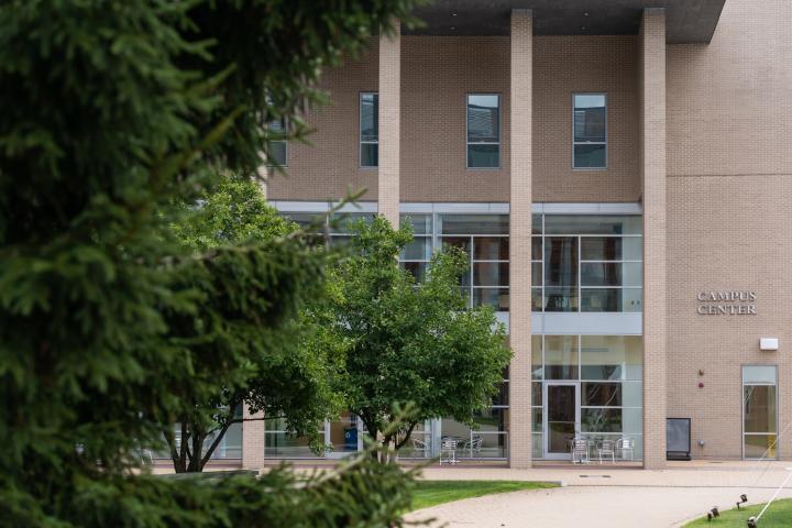 A photo of a beige colored building with several windows