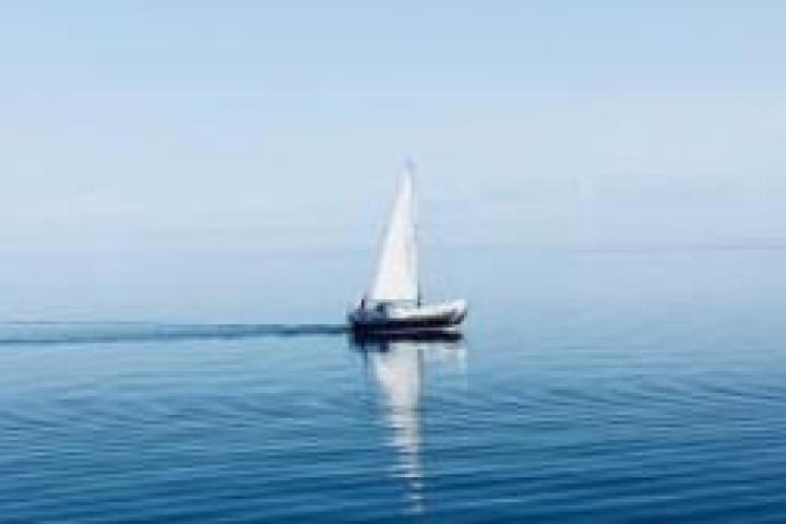 A white sailboat in the ocean.