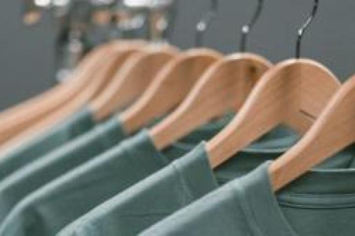 Closeup of a rack of t-shirts on hangers.