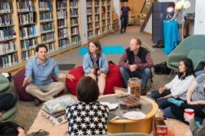 People sitting in a circle in the library.