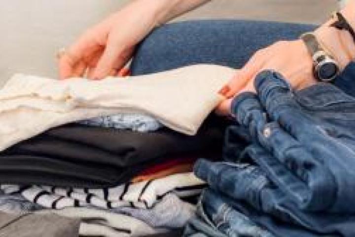 A closeup of a person folding clothes.