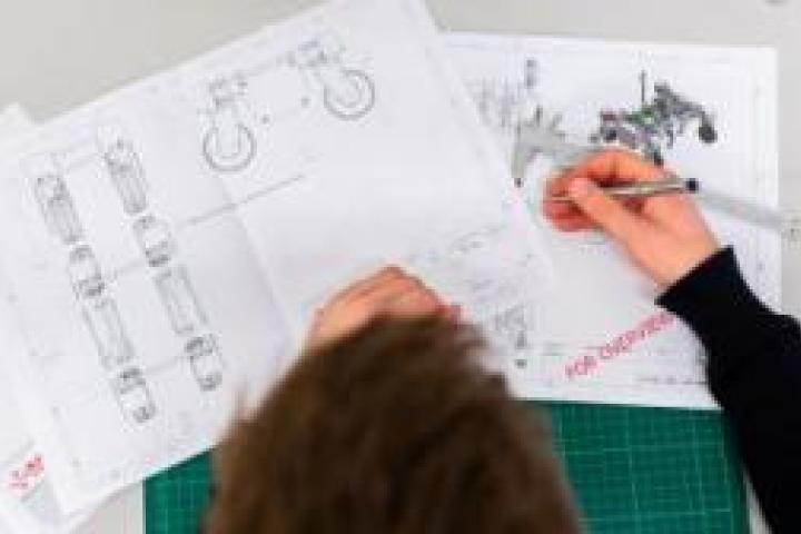 A person drawing blueprints