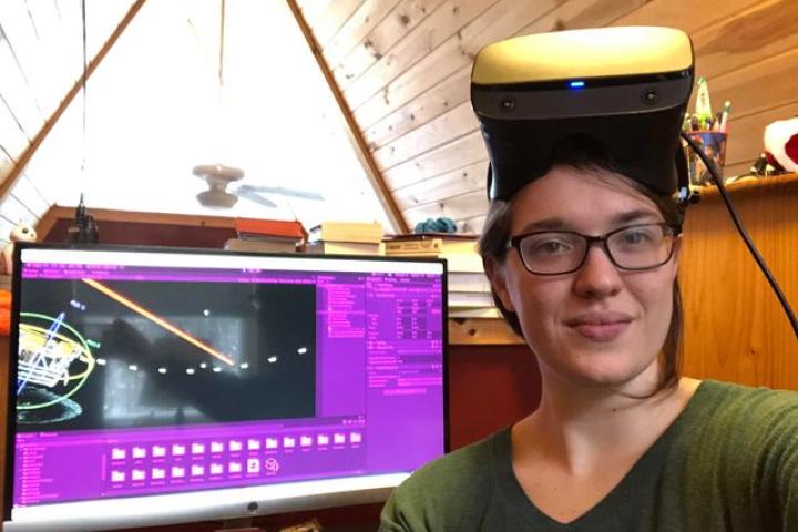 Cali Wierzbanowski ’21 poses with the team's state-of-the-art software and VR headset.