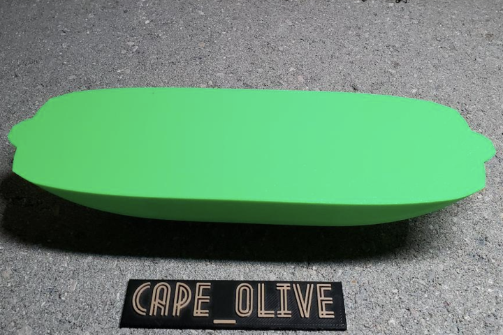 A green, oval-shaped, 3D printed boat with the words "Cape_Olive" printed underneath it.
