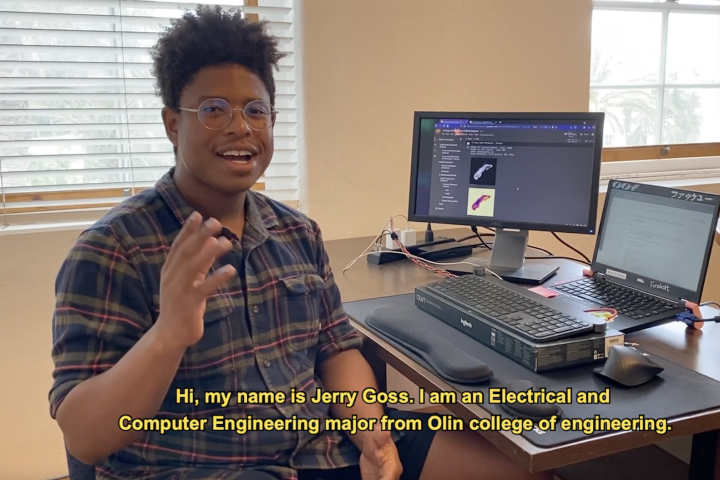 Student, Jerry Goss '23, in glasses, sitting at computer in Bermuda. 