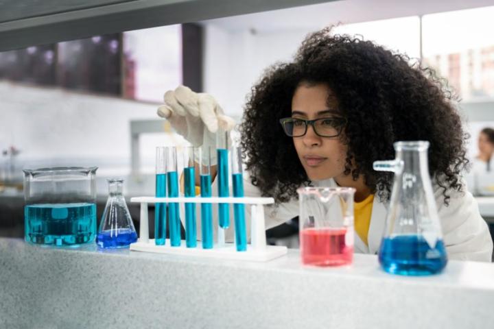 A photo of a student in a lab coat conducting experiments