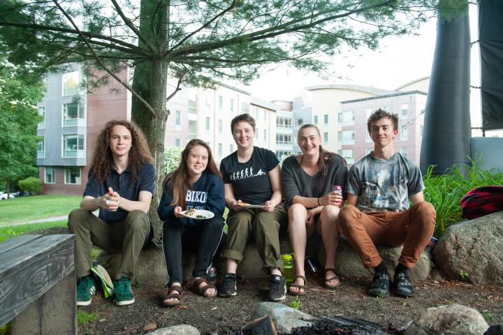 Olin College students A group of five people sitting on a large rocks under a tree