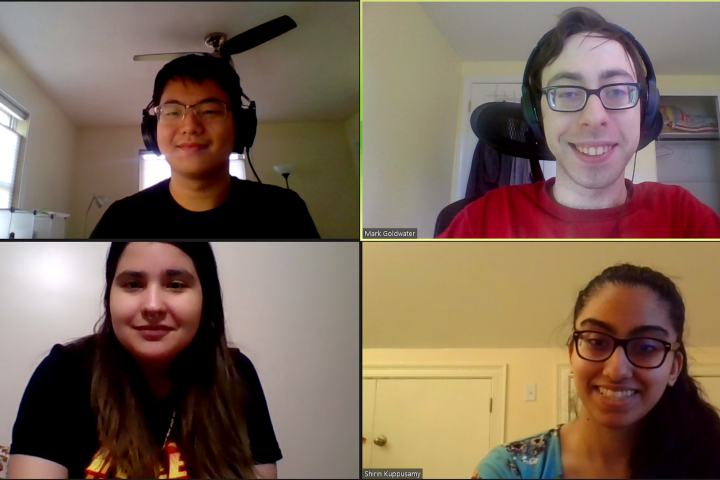 Four students, three with glasses and all smiling, shown in a screenshot from a zoom call. 