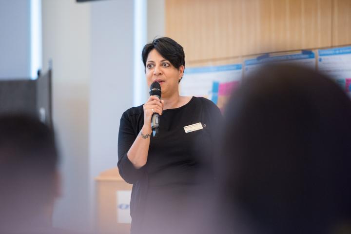 Debbie Chachra, professor of engineering, holds a mic and speaks on campus in 2018.