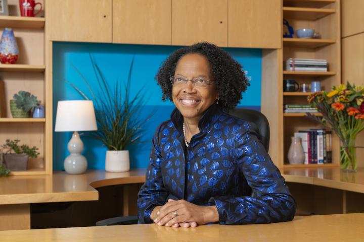 A photo of President Barabino behind her desk