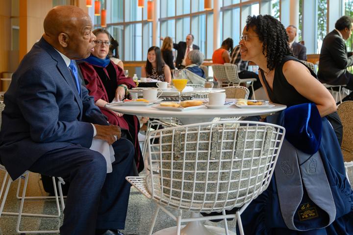 A photo of President Gilda Barabino sitting across the table from John Lewis