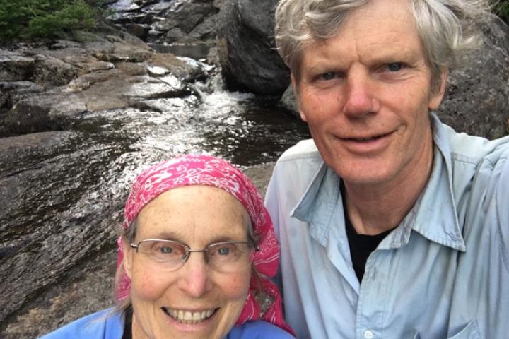 Olin College parents Malinda and Glen Chapman A photo of a couple standing in front of a stream