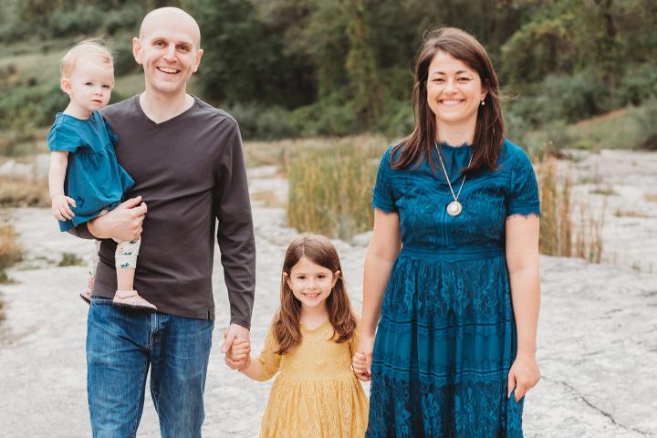 Jay Gantz '06, walks with wife Aura Gantz and children in 2021 A man with a brown shirt and jeans walks hand-in-hand with his wife in blue dress and two children in 2021