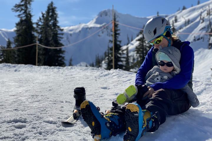 Jaime Curtis '12 with daughter Cedar Curtis (7mo) attempting to ski at Mount Baker in 2022. Jaime Curtis '12 on ski slope with daughter (7mo) attempting to ski at Mount Baker in 2022.