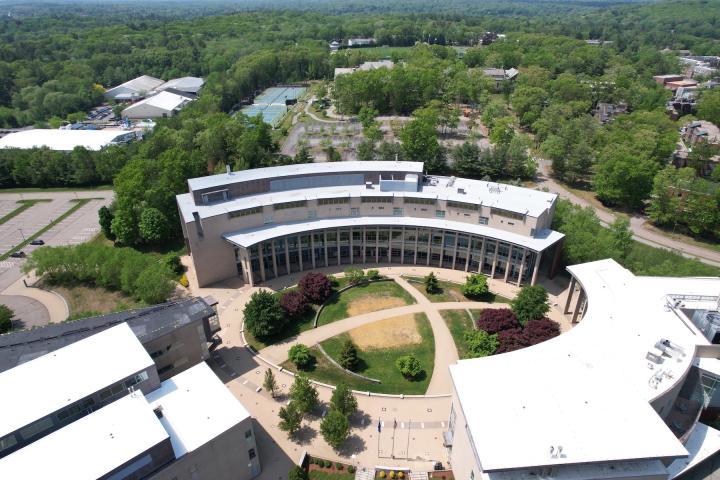 Olin College's campus in the fall is seen from above in a drone image.