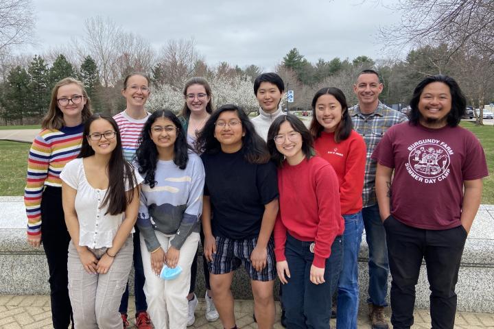 A large group of students and a couple of faculty members pose for a photo. 