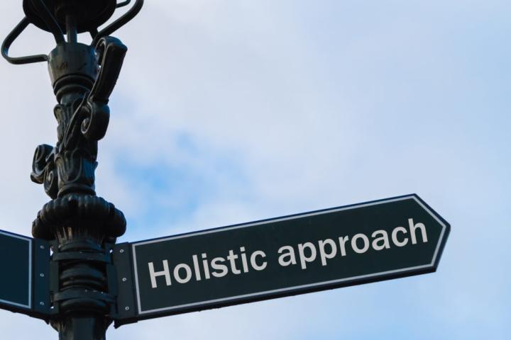 Street sign that says Holistic approach