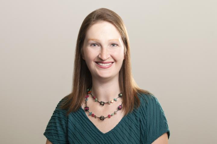 Woman in green shirt smiles