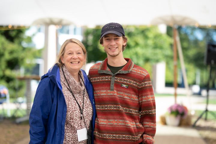 Parent and student standing in Olin O smiling at camera