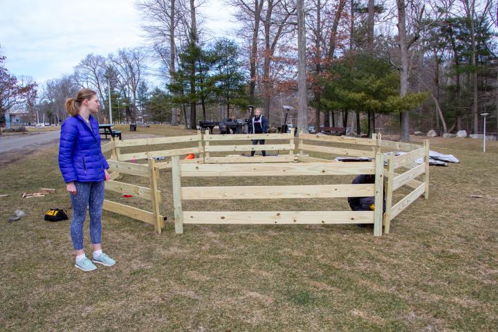 People stand around a newly-built Ga-Ga-Ball pit.