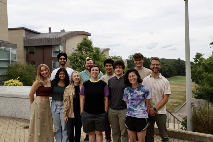 residence life staff 2022-2023 with residence halls in the background