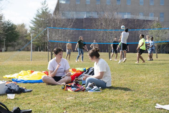 students on great lawn with volleyball in background