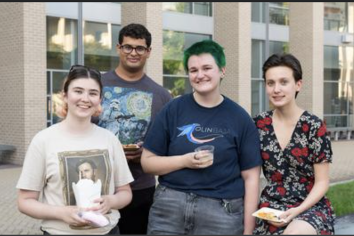 A photo of four Olin College students standing together outside