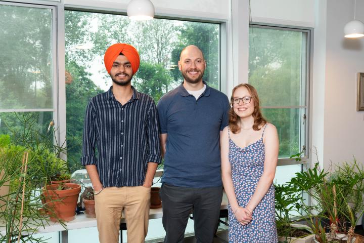 Summer team picture - Anmol, Erhardt, and Bethany standing together and smiling at camera