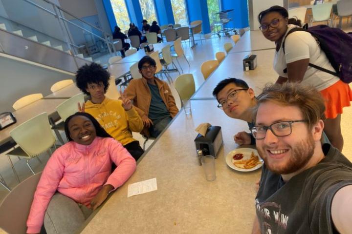 multiple Olin students sitting at the dining hall taking a selfie