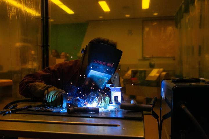 Olin student working in the shop welding