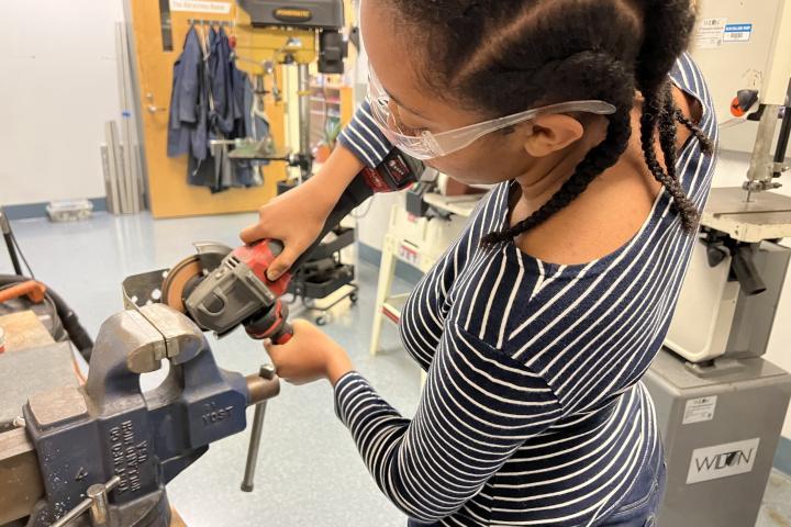 Mahderekal Regassa (Wellesley College '24,) a member of the PEEP Lab works with a tool in the Olin Shop.
